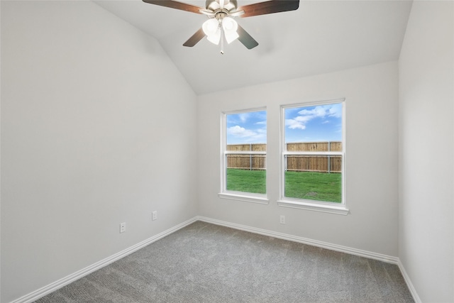 empty room with baseboards, carpet flooring, a ceiling fan, and vaulted ceiling