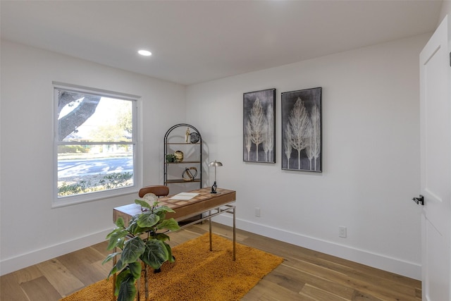 office space featuring baseboards, wood finished floors, and recessed lighting