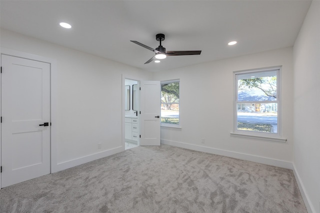 unfurnished bedroom with carpet, multiple windows, baseboards, and recessed lighting