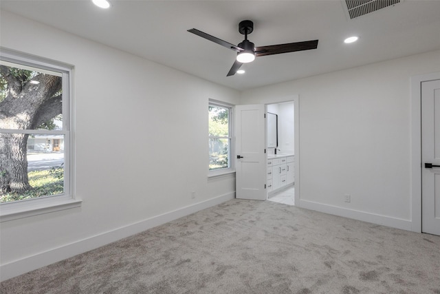 unfurnished bedroom with ensuite bathroom, recessed lighting, carpet floors, visible vents, and baseboards