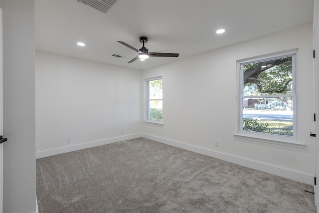 carpeted empty room with recessed lighting, visible vents, and baseboards