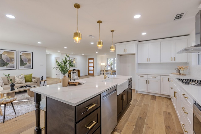 kitchen with appliances with stainless steel finishes, recessed lighting, a sink, and light wood-style flooring