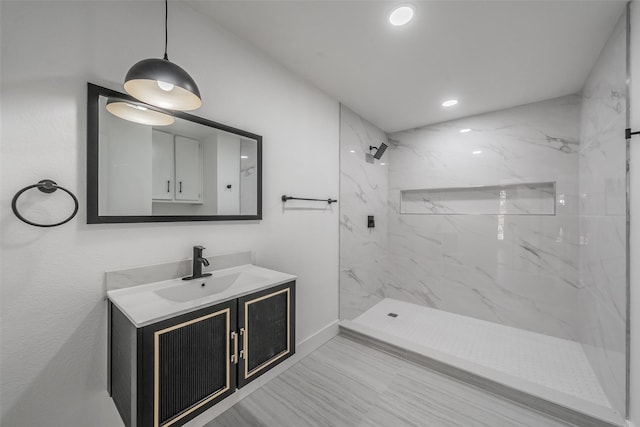 full bath featuring recessed lighting, a marble finish shower, and vanity