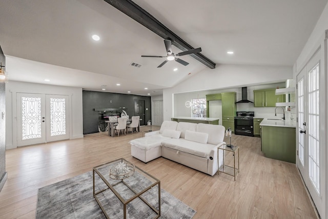 living area featuring light wood finished floors, visible vents, vaulted ceiling with beams, french doors, and recessed lighting