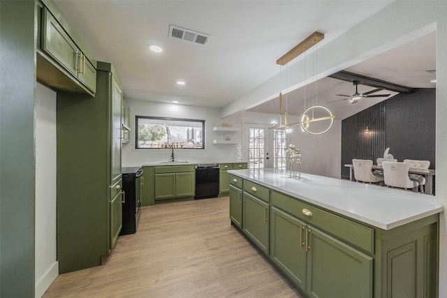 kitchen with a sink, visible vents, green cabinets, light wood-type flooring, and dishwasher