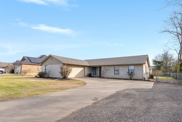 view of front facade featuring a garage, driveway, a gate, a front lawn, and brick siding