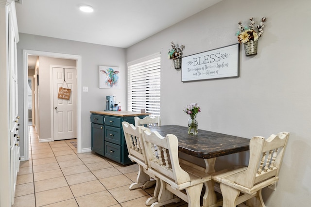 dining area with baseboards and light tile patterned floors