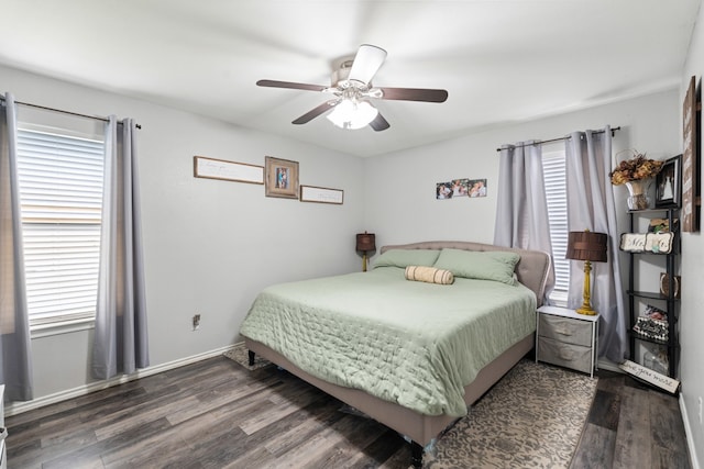 bedroom featuring dark wood-style floors, baseboards, and a ceiling fan