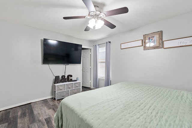 bedroom featuring a ceiling fan, baseboards, and dark wood-type flooring