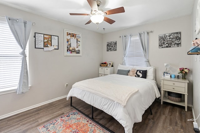 bedroom with multiple windows, ceiling fan, baseboards, and wood finished floors