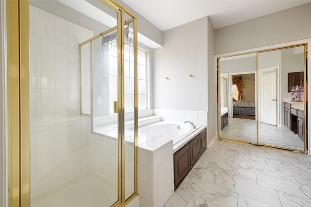 full bath featuring marble finish floor, a garden tub, a shower stall, and ensuite bath