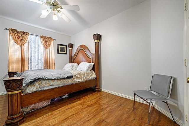 bedroom featuring ceiling fan, baseboards, and wood finished floors