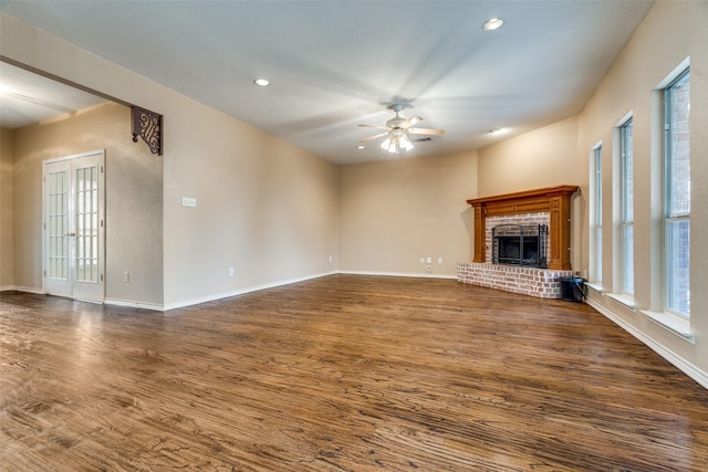 unfurnished living room with baseboards, a ceiling fan, dark wood-style floors, a brick fireplace, and recessed lighting