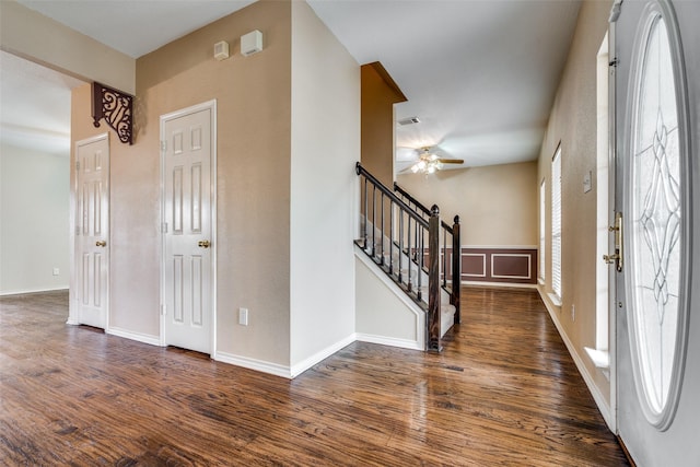 foyer featuring dark wood-style floors, visible vents, stairway, ceiling fan, and baseboards