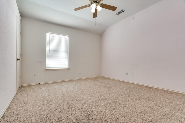 unfurnished room featuring vaulted ceiling, carpet, visible vents, and a ceiling fan