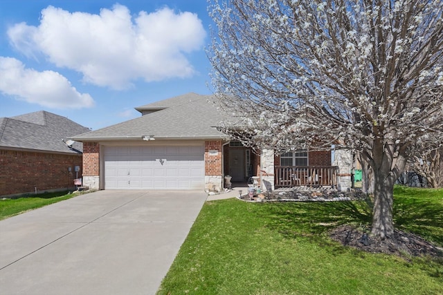 view of front of property with a front lawn, a garage, brick siding, and concrete driveway