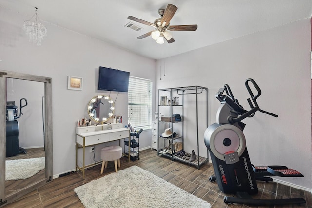 workout area featuring visible vents, baseboards, a ceiling fan, and wood finished floors