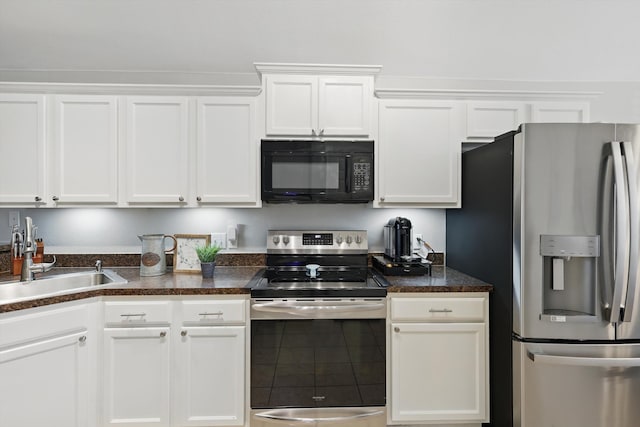 kitchen featuring white cabinets, appliances with stainless steel finishes, and a sink