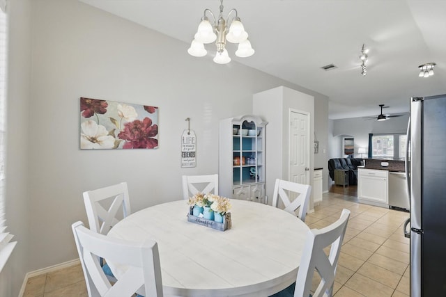 dining area with visible vents, a notable chandelier, track lighting, light tile patterned flooring, and baseboards