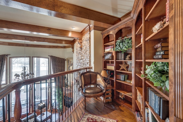 sitting room featuring beamed ceiling, an inviting chandelier, and wood finished floors