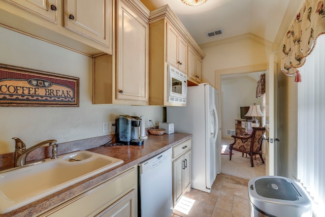 kitchen featuring white appliances, visible vents, a sink, and ornamental molding