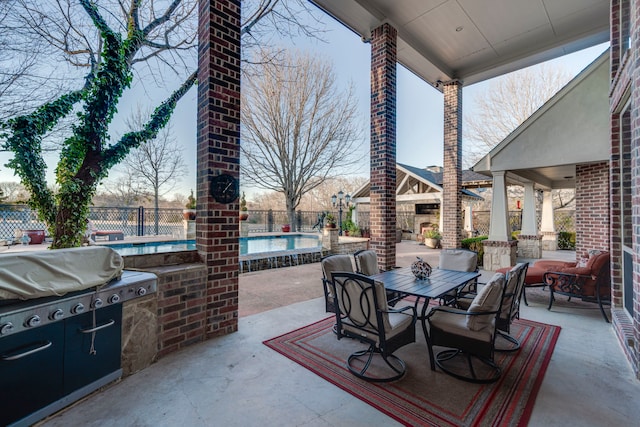 view of patio / terrace with outdoor dining space, a fenced backyard, and a community pool