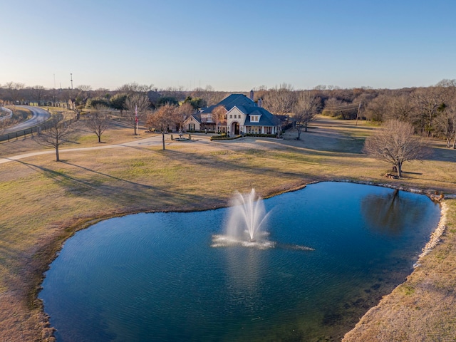 view of pool featuring a water view and a lawn