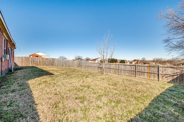 view of yard featuring cooling unit and a fenced backyard