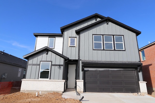 modern farmhouse with an attached garage, driveway, board and batten siding, and brick siding