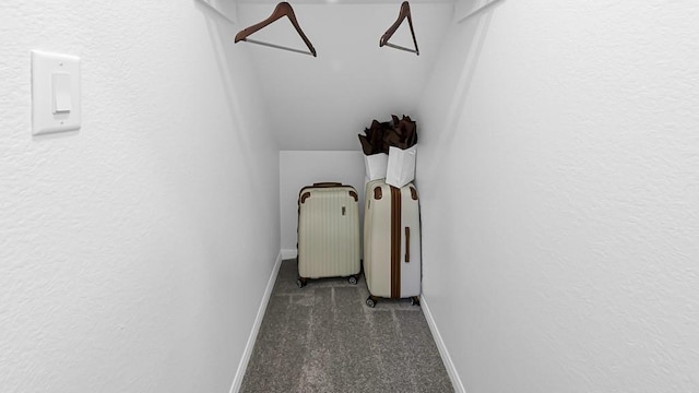 hallway featuring carpet floors, radiator, baseboards, and vaulted ceiling