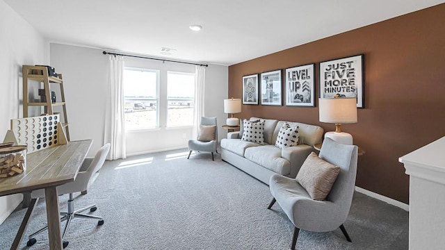 living area with carpet floors, visible vents, and baseboards