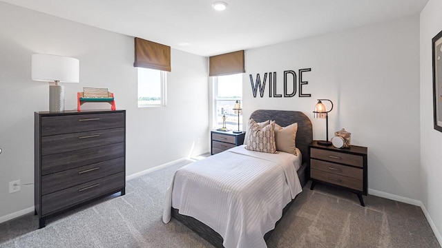 bedroom with carpet floors and baseboards