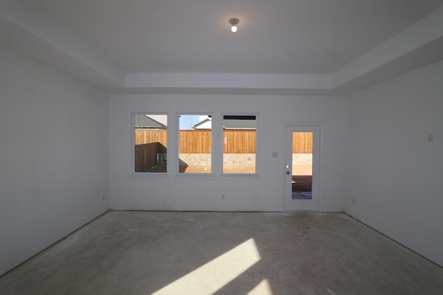 unfurnished room featuring a raised ceiling