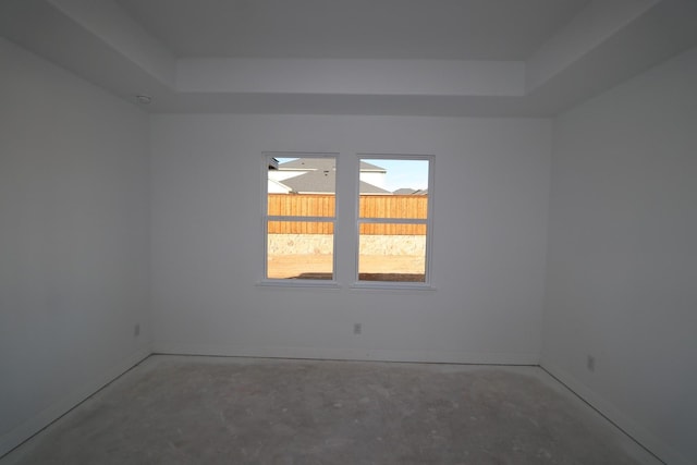 empty room featuring baseboards and concrete flooring