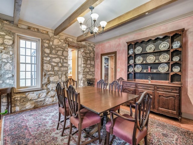 dining room with light wood-style floors, crown molding, beamed ceiling, and an inviting chandelier