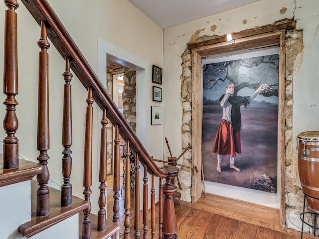 entrance foyer featuring stairway and wood finished floors