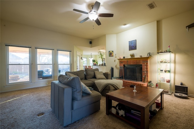 living room with ceiling fan, carpet, visible vents, and a brick fireplace