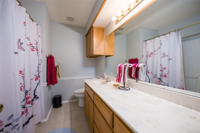 bathroom featuring visible vents, toilet, vanity, baseboards, and tile patterned floors