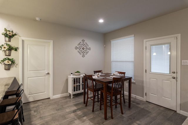 dining room with recessed lighting, dark wood-style flooring, and baseboards