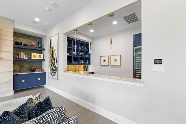 interior space featuring recessed lighting, visible vents, baseboards, and wood finished floors