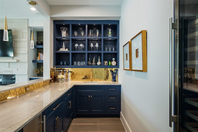 bar with wine cooler, decorative backsplash, a sink, wood finished floors, and wet bar