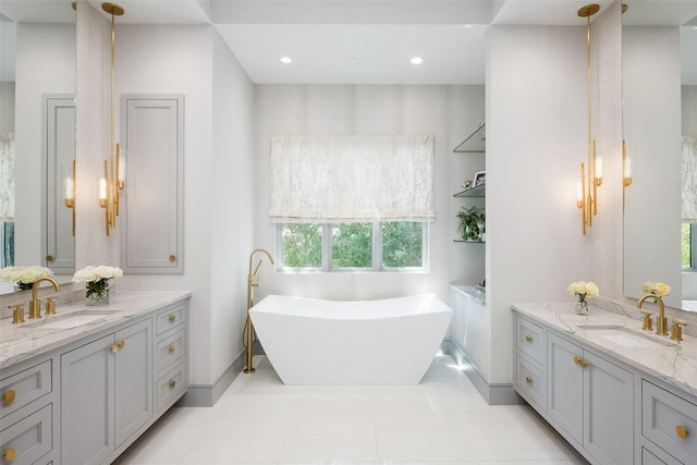 full bathroom featuring a freestanding tub, two vanities, and a sink