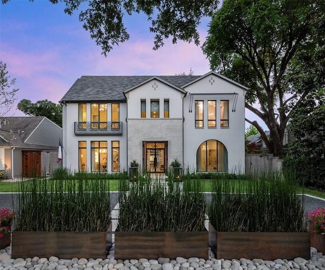 view of front of home featuring a fenced front yard and a balcony