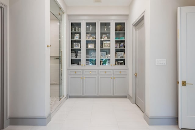 corridor featuring light tile patterned flooring