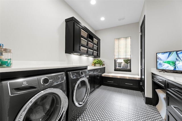 clothes washing area with washer and dryer, cabinet space, visible vents, and recessed lighting