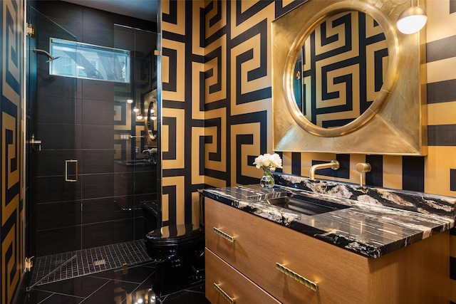 full bathroom featuring a shower stall, toilet, and vanity