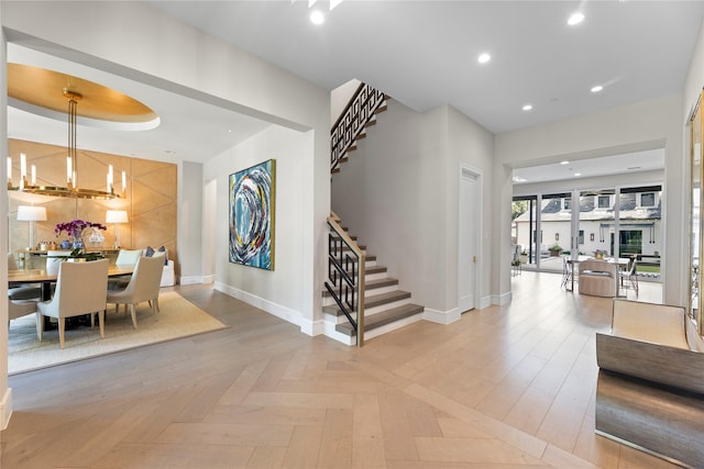 foyer featuring stairs, an inviting chandelier, baseboards, and recessed lighting