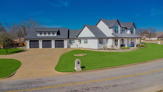 modern farmhouse style home with a garage, driveway, a porch, and a front lawn