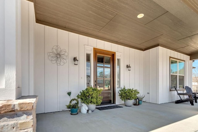 entrance to property with a porch and board and batten siding