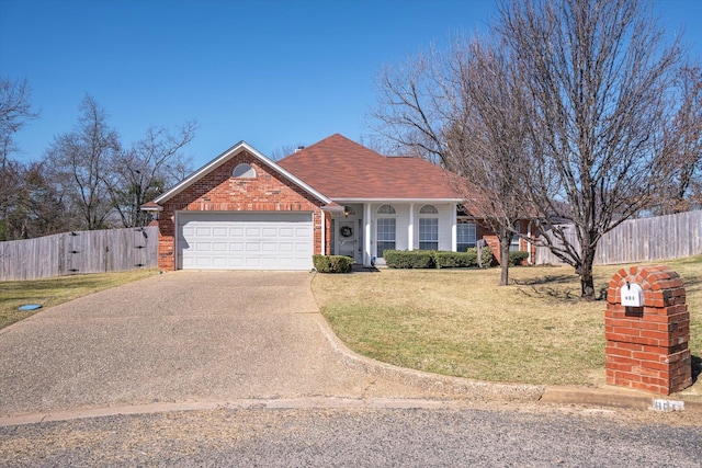 view of front of property featuring a garage, concrete driveway, fence, a front lawn, and brick siding